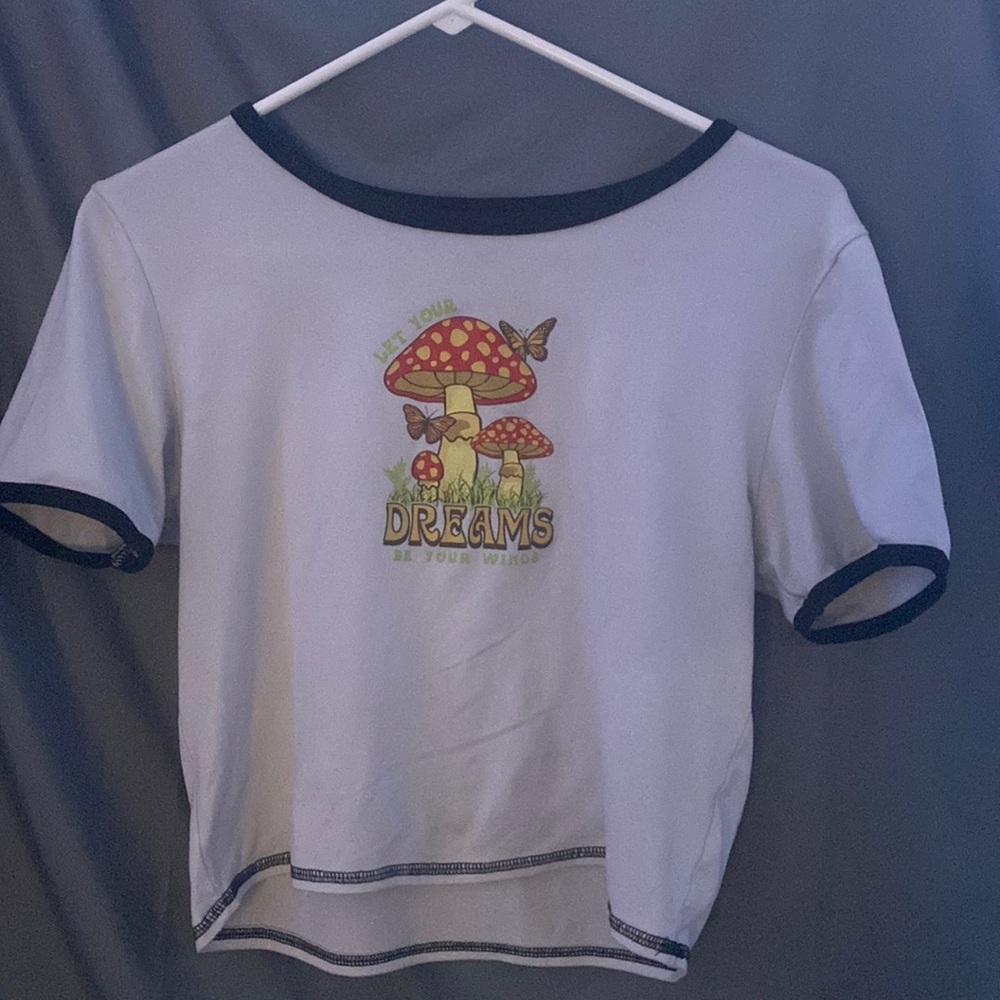 A t shirt with a mushroom on it.